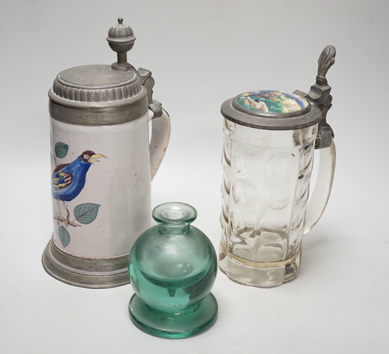 A German faience stein, dated 1819, a glass stein and an inkwell, largest 24cm